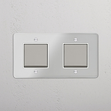 Interruptor doble de balancín en níquel pulido y traslúcido con blanco - Solución moderna y versátil para control de luces, sobre fondo blanco