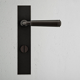 Manilla para puertas Digby con placa larga (con muelle) y sistema giratorio - Bronce