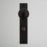 Pomo para puertas Poplar con placa larga (con muelle) y sistema giratorio - Bronce