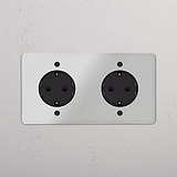 Bases Schuko dobles, inserto negro, marco transparente, para instalación eléctrica en soporte de pared doble.