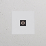 Prise TV (Plaque Simple) avec insert noir à peindre sur un mur blanc, faisant partie de la série Prises & Modules Simple.