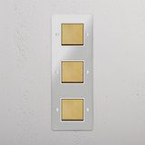 Efficient Light Control Tool: Vertical Triple Rocker Switch in Clear Antique Brass White on White Background