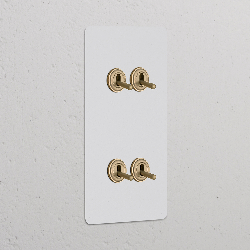 Interruttore a Levetta Doppio Verticale con quattro levette in ottone antico, design Pitturabile Ottone Antico.
