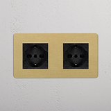 Modulo Doppio 2x Schuko/Bipasso in Ottone Antico Nero con due prese elettriche nere su placca beige.