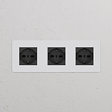 Modulo Schuko/Bipasso a tre prese, colore nero, per tripla potenza, pitturabile, integrabile nella parete bianca.