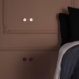 Double 2x Dimmer Switch in paintable polished nickel on a patterned wall, enhancing the room's sophisticated look.