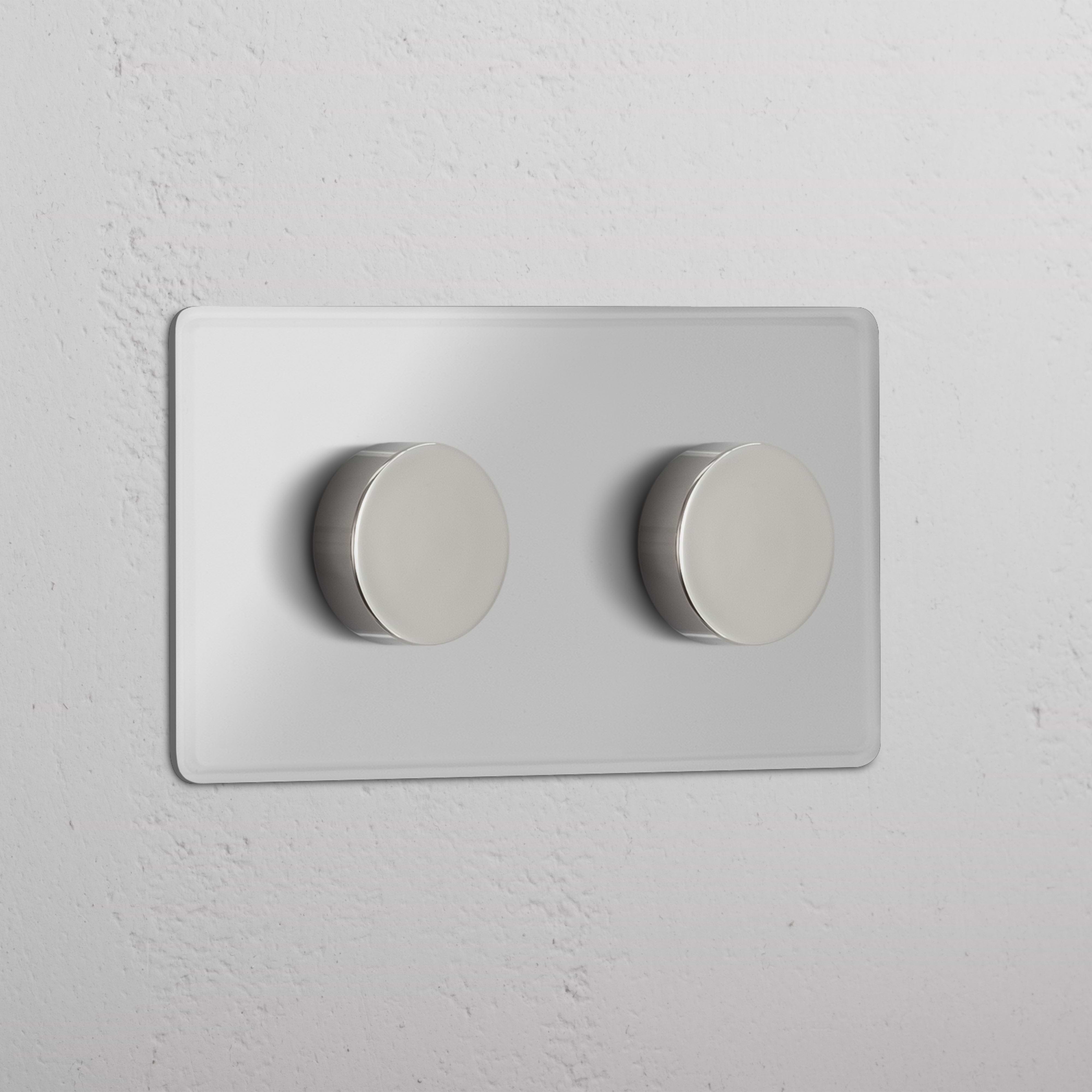Clear Polished Nickel Double 2x Multiway Dimmer Switch with two round knobs, mounted on a white wall.