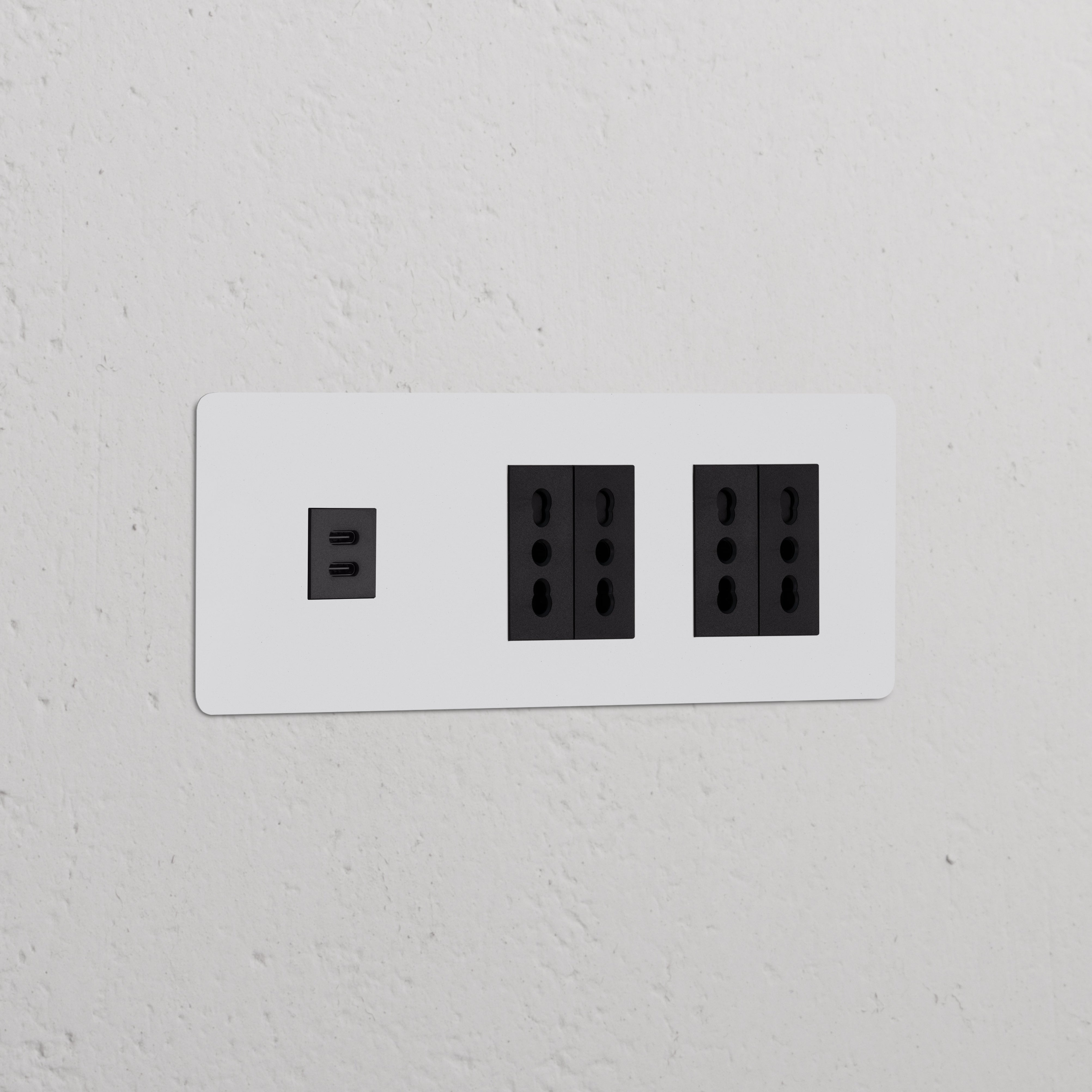 Black Triple USB 30W & 4x Bipasso Power Module on a wall, featuring paintable finish for seamless integration.