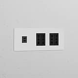 Black Triple USB 30W & 4x Bipasso Power Module on a wall, featuring paintable finish for seamless integration.