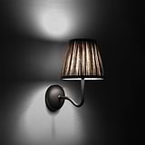 Medium Malvern Wall Light in Natural Beige at an angle and turned on at night