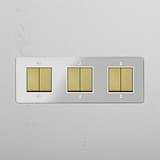Comprehensive Light Management Tool: Six-Position Triple Rocker Switch in Clear Antique Brass White on White Background