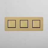 Antique Brass Black Triple Rocker Switch with Three Switching Positions on White Background
