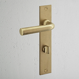 Apsley Long Plate Sprung Door Handle & Thumbturn Antique Brass Finish on White Background at an Angle