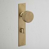 Onslow Long Plate Sprung Door Knob & Thumbturn Antique Brass Finish on White Background at an Angle