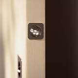 Close-up of a Regent Recessed Edge Pull in polished nickel installed on a door.