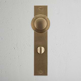 Poplar Long Plate Sprung Door Knob & Thumbturn Antique Brass Finish on White Background right Facing Front View