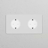 Paintable white Double 2x Schuko Type F power module for sockets on a gray wall.
