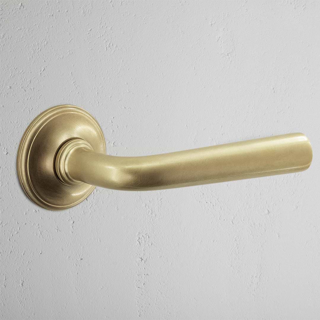 Apsley Sprung Door Handle Antique Brass Finish on White Background 