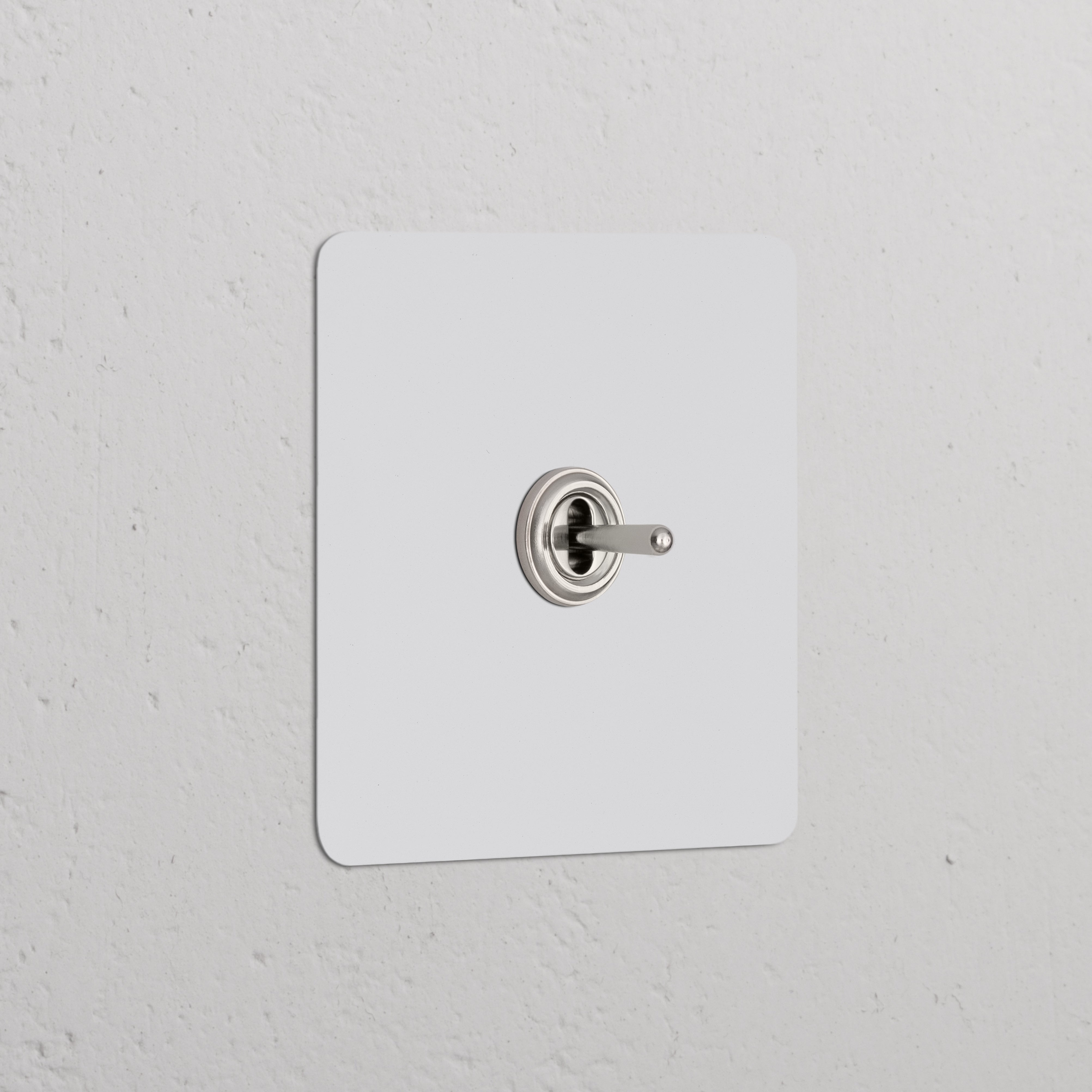 Single Toggle Switch (Cent) Paintable Polished Nickel on a white textured wall, part of Single Switches & Dimmers.