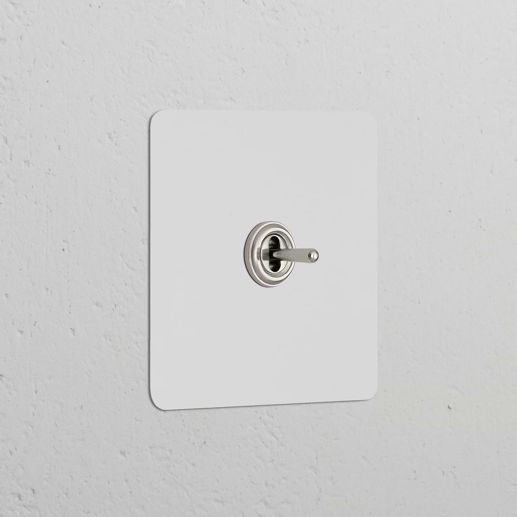 Single Toggle Switch (Cent) Paintable Polished Nickel on a white textured wall, part of Single Switches & Dimmers.