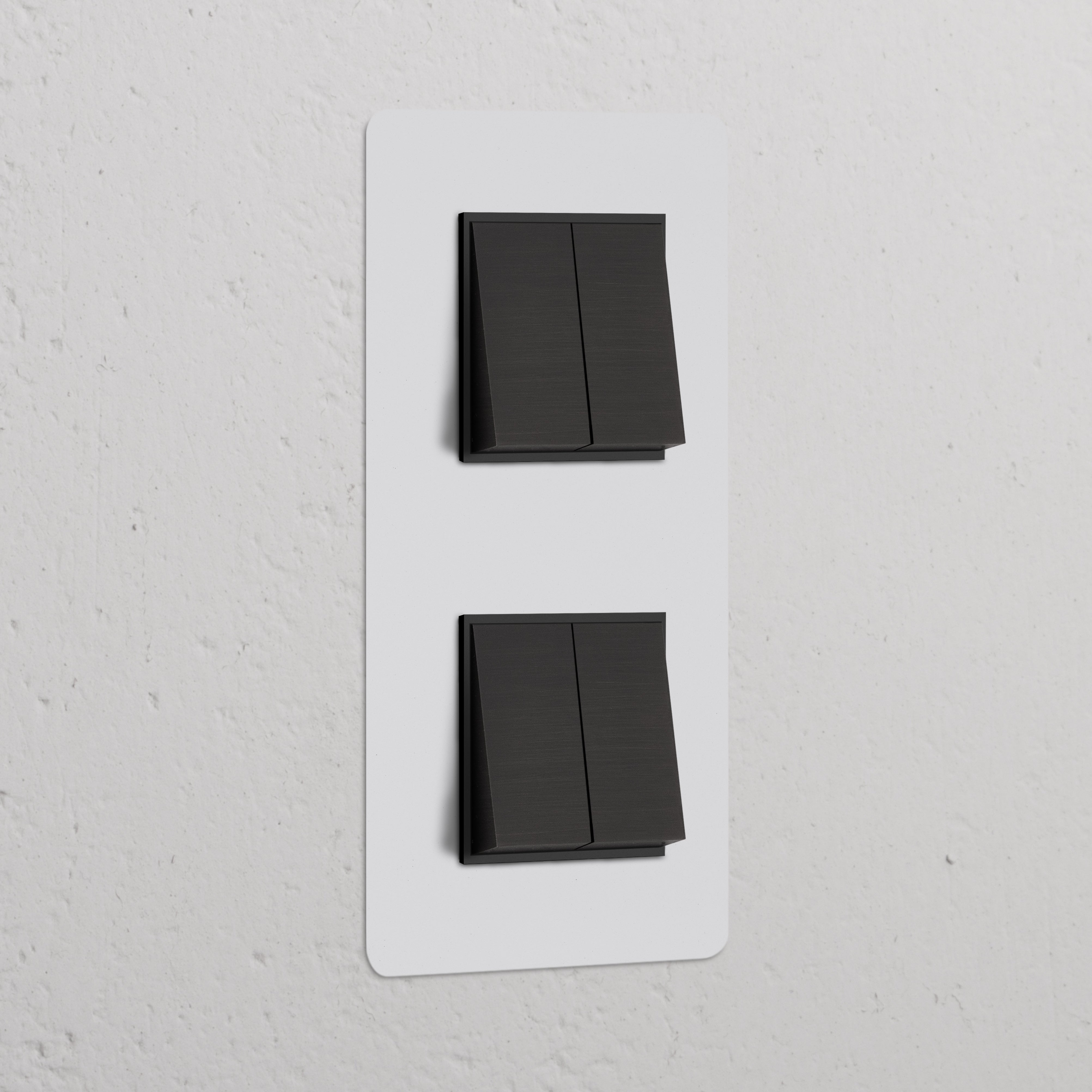 Double 4x vertical rocker switch in paintable bronze black on a white textured wall, for switches & dimmers.