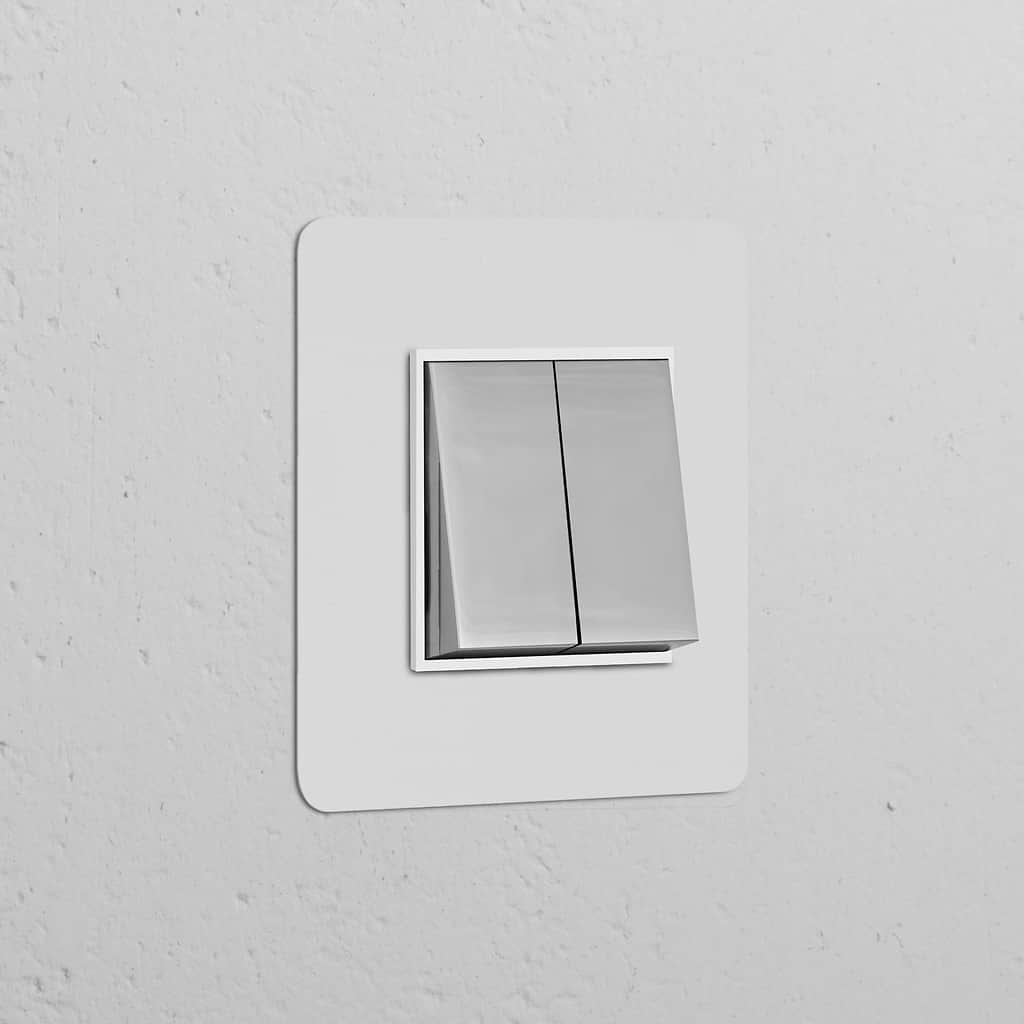 Paintable polished nickel white single 2x rocker switch on a textured white wall.