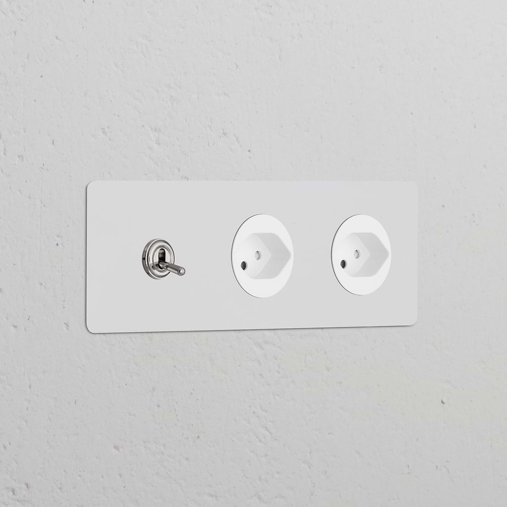 Triple Toggle Switch + 2x Swiss Type J Power Module in Paintable Polished Nickel on a white wall.