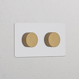 Double 2x Multiway Dimmer Switch with two paintable antique brass knobs on a white rectangular plate.