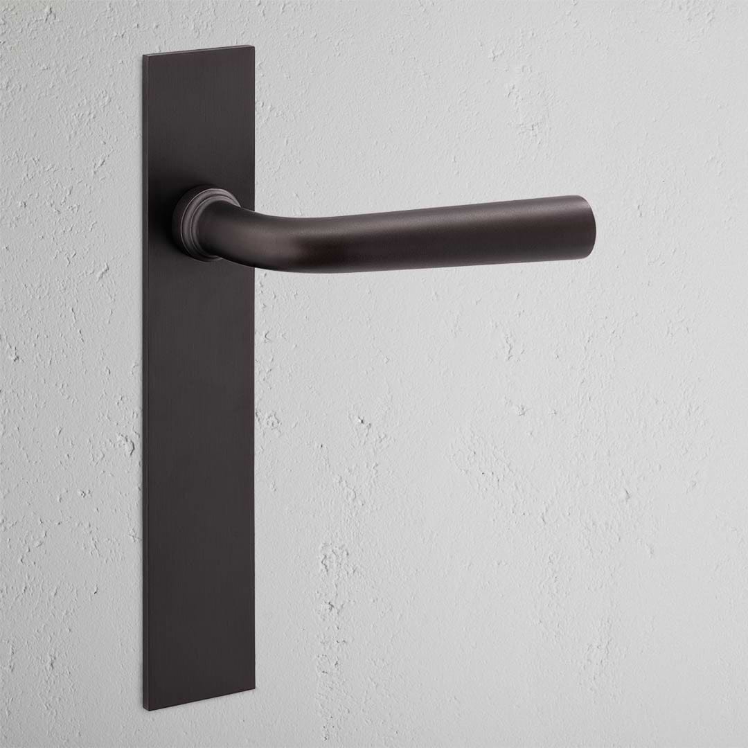 Apsley Long Plate Sprung Door Handle Bronze Finish on White Background