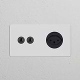 Double 2x Toggle Switch + Swiss Type J Power Module Round in Paintable Bronze Black on a white wall.