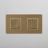 Four Position Double Rocker Switch in Antique Brass White on White Background