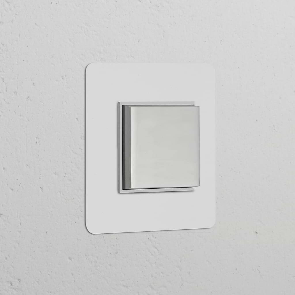 Single rocker switch in polished nickel white on a textured white wall, part of the Single Switches & Dimmers collection.