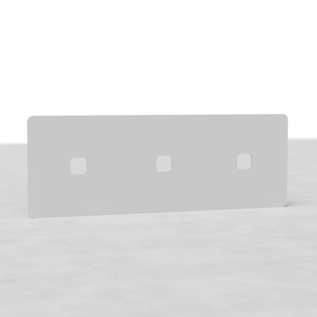 White rectangular EU paintable switch plate with three square cutouts for switches, placed on a light surface.