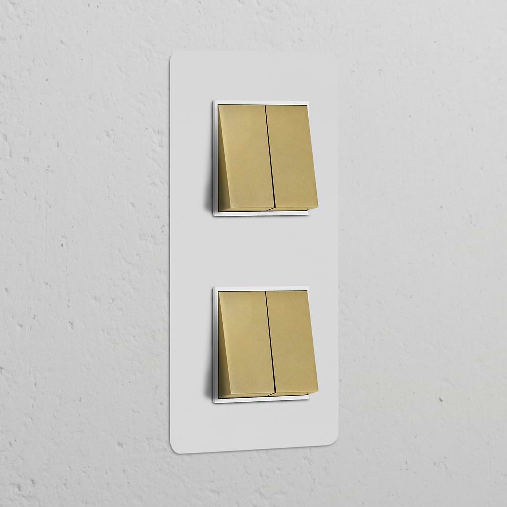 Paintable antique brass double vertical rocker switch blends with white textured wall, offering elegance and function.