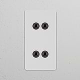 Double 4x vertical toggle switch in paintable bronze for sleek control; part of double vertical switches & dimmers.
