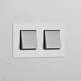 Double 2x Rocker Switch in polished nickel with paintable black finish for modern home lighting.
