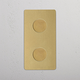 Antique Brass Double 2x Vertical Multiway Dimmer Switch with two round knobs on a white textured wall.