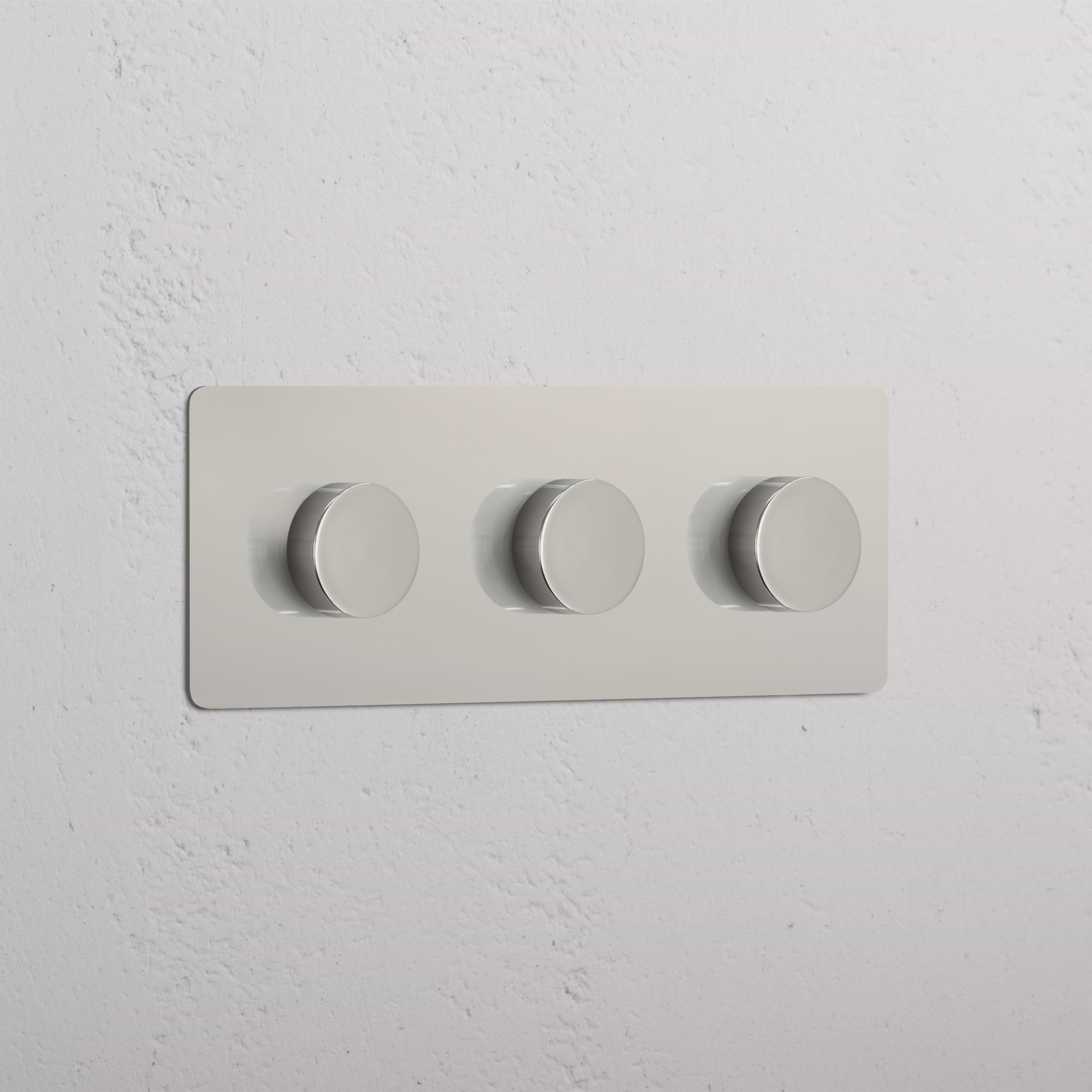 Triple 3x Multiway Dimmer Switch in polished nickel with three horizontal knobs mounted on a wall.