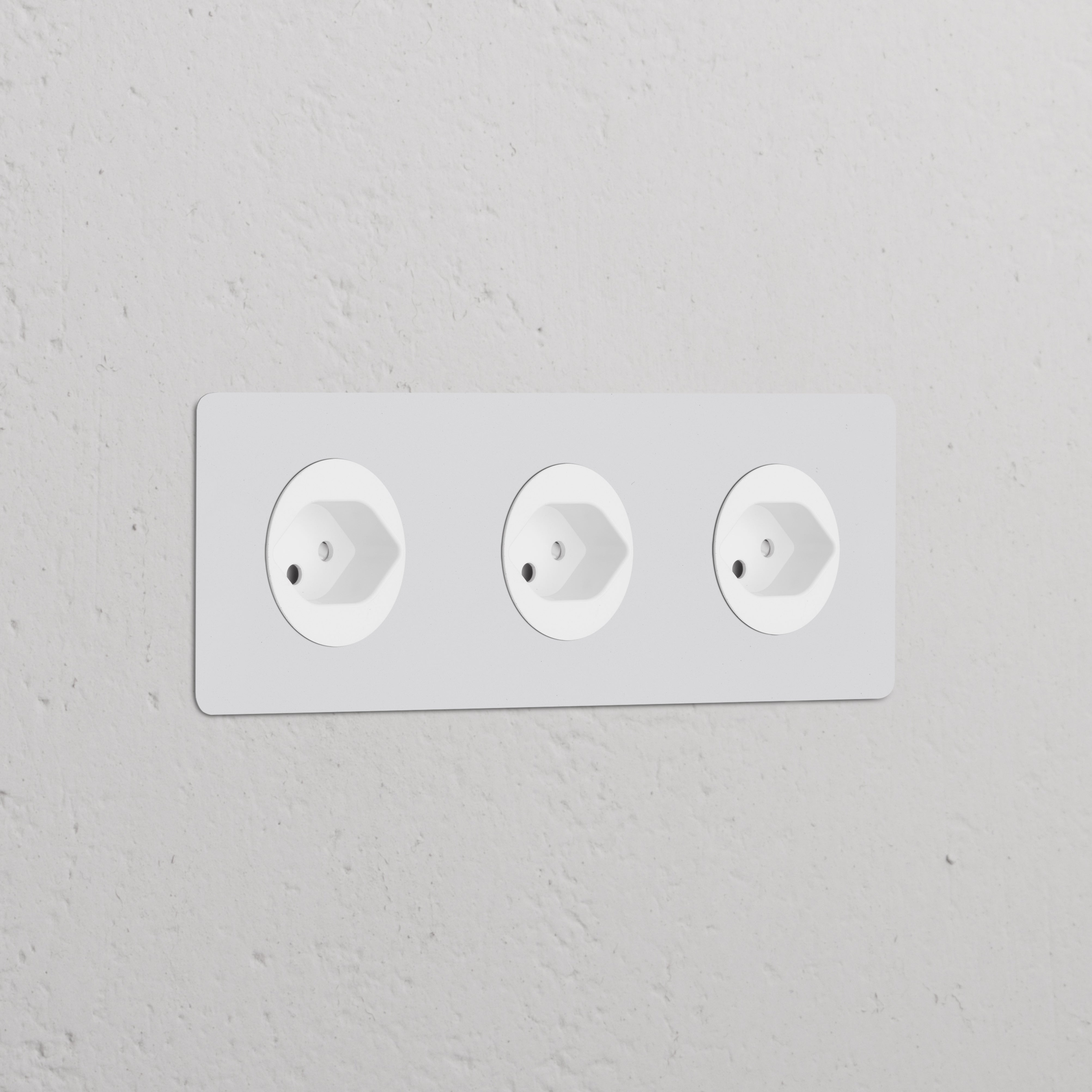 Triple 3x Swiss Type J Power Module with round paintable white sockets, seamlessly integrated into a white wall.