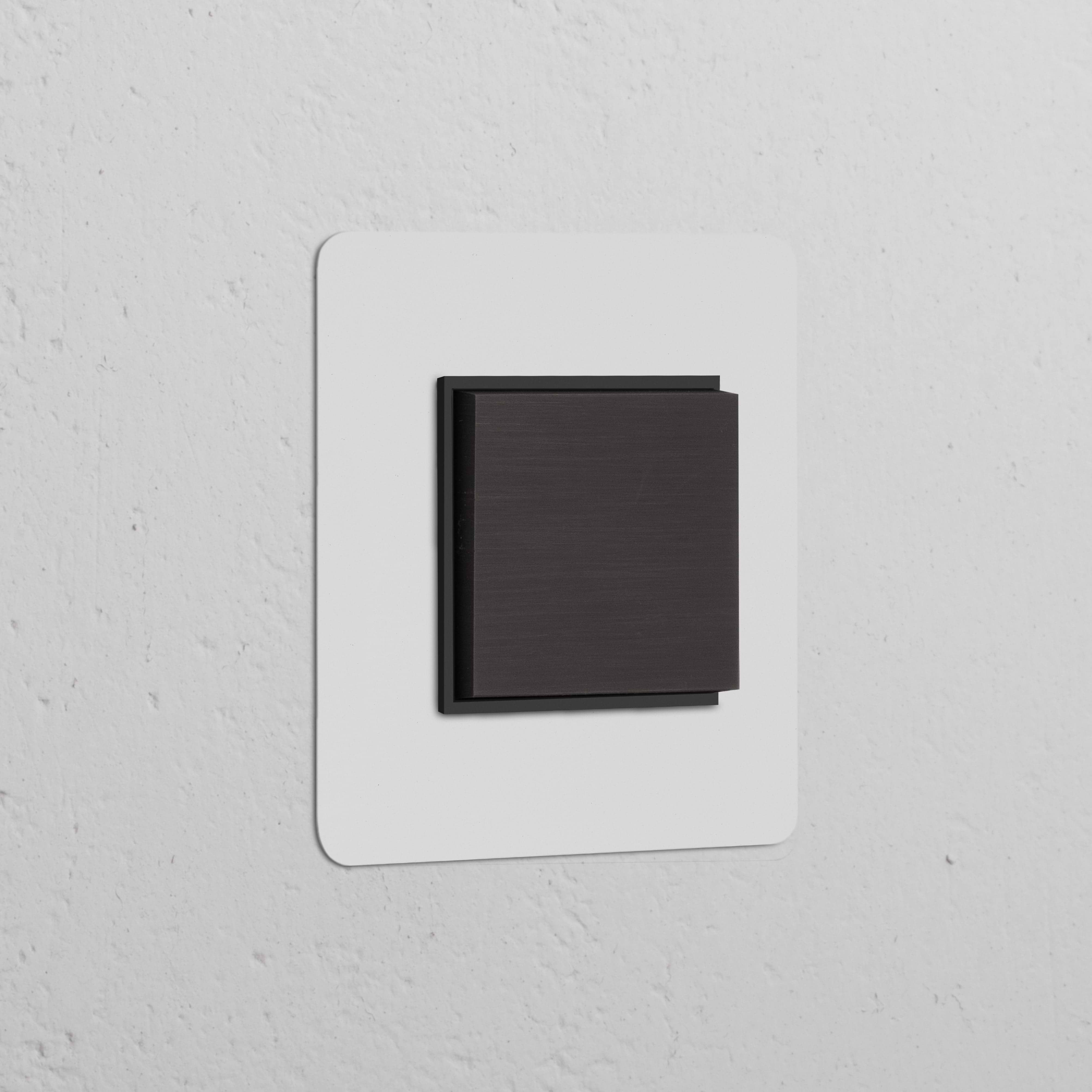 Single Rocker Switch (Cent) – Paintable Bronze Black mounted on white wall, ideal for Single Switches & Dimmers.