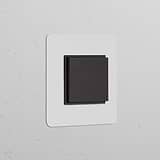 Single Rocker Switch (Cent) – Paintable Bronze Black mounted on white wall, ideal for Single Switches & Dimmers.