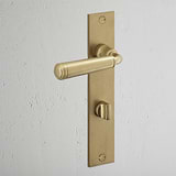 Digby Long Plate Sprung Door Handle & Thumbturn Antique Brass Finish on White Background at an Angle