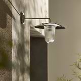 Medium Kensington Wall Light Fluted Glass in polished nickel with ribbed glass shade, mounted on beige wall.