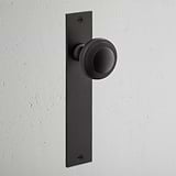 Poplar Long Plate Fixed Door Knob Bronze Finish on White Background at an Angle