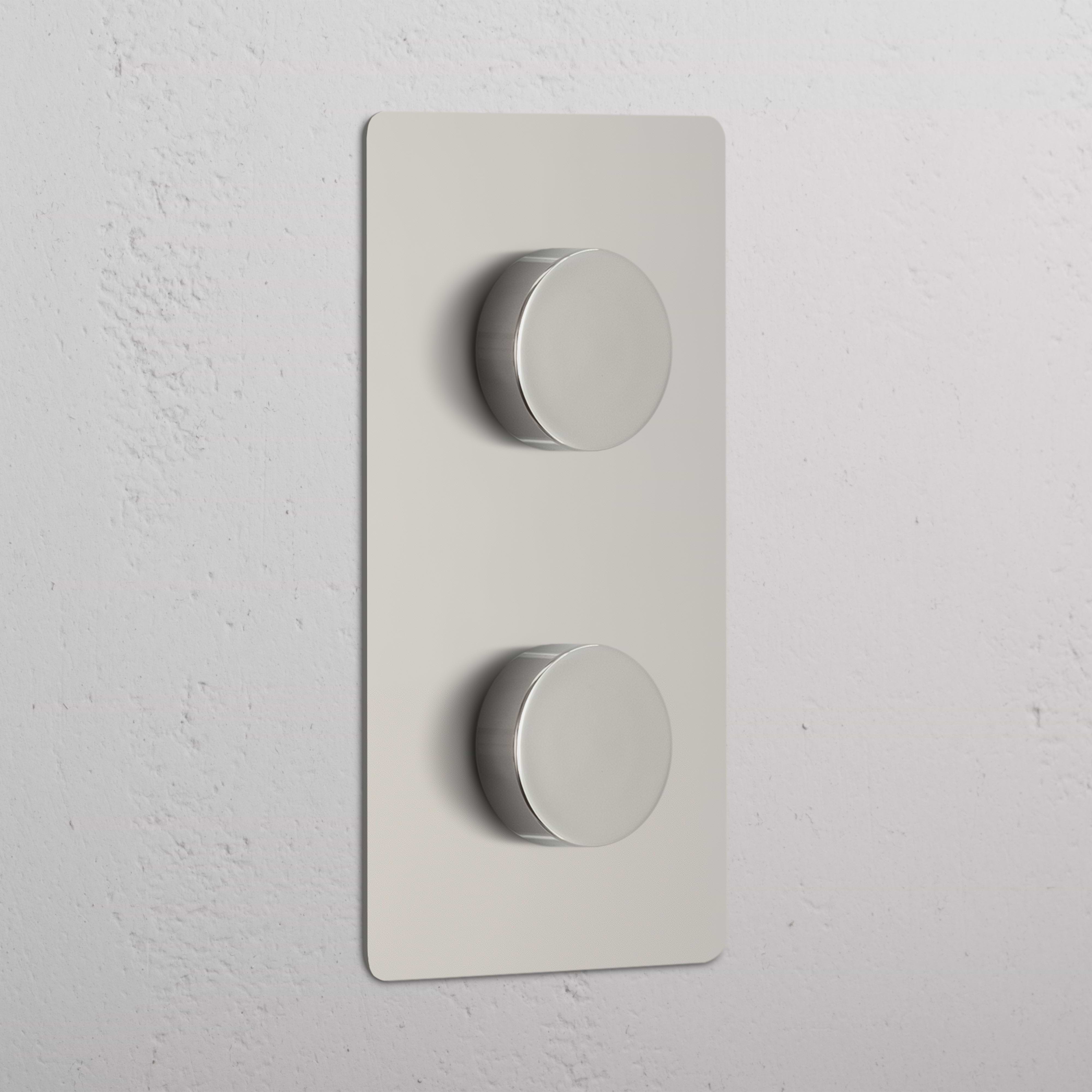 Double 2x Vertical Multiway Dimmer Switch in polished nickel with two round knobs on a wall plate.