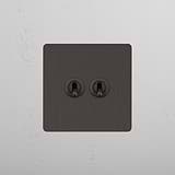 Double Toggle Switch in Bronze with 2 Levers on White Background