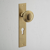 Poplar Long Plate Sprung Door Knob & Euro Lock Antique Brass Finish on White Background at an Angle