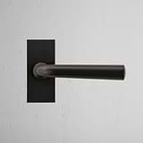 Apsley Short Plate Sprung Door Handle Bronze Finish on White Background Front Facing