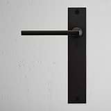Clayton Long Plate Sprung Door Handle Bronze Finish on White Background right Facing Front View