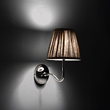 Medium Malvern Wall Light in Natural Beige at an angle and turned on at night
